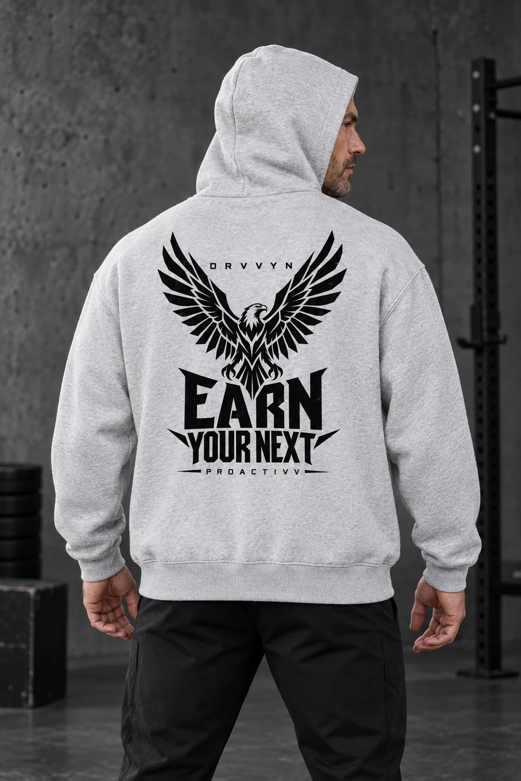 DRVVYN Proactivv Earn Your Next — Gray boxy fleece hoodie with black eagle back print, male model