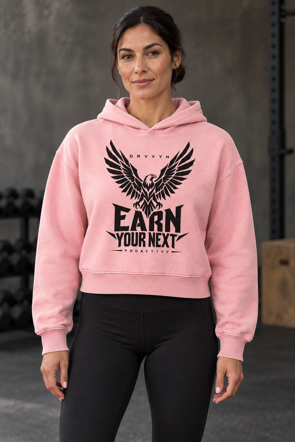 DRVVYN Proactivv Earn Your Next — Pink cropped heavyweight hoodie with black eagle front print, female model